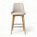 Upholstered bar stool in beige fabric with natural wood legs and chrome footrest 45 x 50 x 100cm